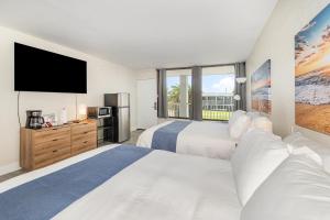 a bedroom with two beds and a flat screen tv at 2050 E IRLO BRONSON 1BED in Kissimmee +8 photos