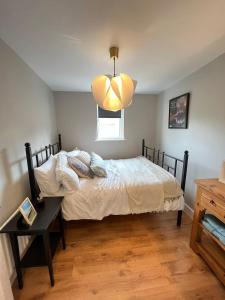 a bedroom with a bed and a table and a window at 3 Bedroom, 5 Bed Home in the Heart of Galway in Galway