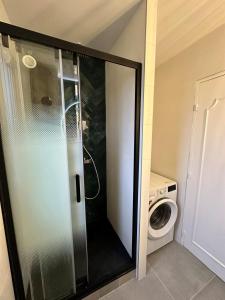 a shower in a bathroom with a washing machine at Superb apartment near RER A free parking in Boissy-Saint-Léger