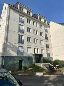 a large gray building with a lot of windows at Superb apartment near RER A free parking in Boissy-Saint-Léger