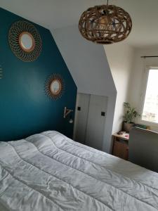 a bedroom with a bed and two mirrors on the wall at Superb apartment near RER A free parking in Boissy-Saint-Léger