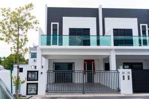 a white house with a balcony on top of it at SpaciousFun4BR Home 9Pax 3Bath Snooker ALMA in Bukit Mertajam