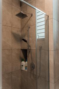 a shower stall with a glass door with a shower at SpaciousFun4BR Home 9Pax 3Bath Snooker ALMA in Bukit Mertajam