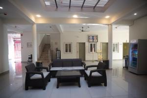 a living room with a couch and chairs in it at Prem Sadan, Pandokhar Sarkar Dham in Indargarh