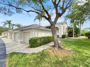 a house with a tree in the yard at Stoneybrook Condo #926 in Sarasota