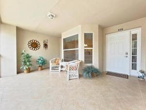 a porch with a white door and a table and chairs at Stoneybrook Condo #926 in Sarasota