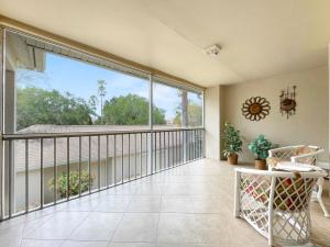 a balcony with a large window and a table and chairs at Stoneybrook Condo #926 in Sarasota +25 photos