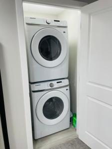 a washer and dryer in a small room at Modern 2-bed 1-bath Suite in Calgary +12 photos