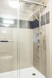 a shower with a glass door in a bathroom at Super 8 by Wyndham Mont Laurier in Mont-Laurier