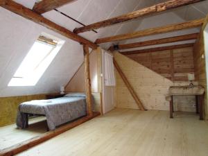 a bedroom in a attic with a bed and a window at Joe's Place in Log pod Mangartom +14 photos