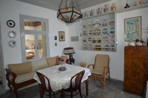 a living room with a couch and a table and chairs at V. Molova, Molyvos, Lesvos in Mithymna
