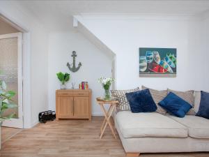 a living room with a couch and a table at Jubilee Cottage in Dawlish