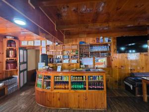 a bar in a room with wooden walls at Mountain View Lodge - 1 Minute from Lukla Airport in Lukla