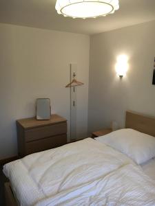 a bedroom with a bed and a clock and a light at Casa Manderscheid in Manderscheid
