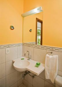 Pousada Gente Bonita La Mansion في بوزيوس: حمام مع حوض ومرآة