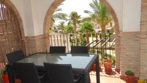 a patio with a table and chairs on a balcony at Vera Rental Thalassa I in Vera