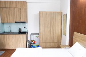 eine Küche mit Holzschränken und Kühlschrank in der Unterkunft Big Church Homestay in Hanoi