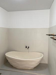 a large white bath tub in a white bathroom at Villa Bulan by MentariPro Bali in Singaraja