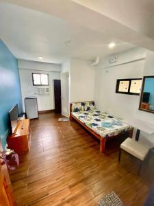 a room with a bed and a desk in it at FFG EDEN PRIVATE RESORT Moalboal in Cansojong