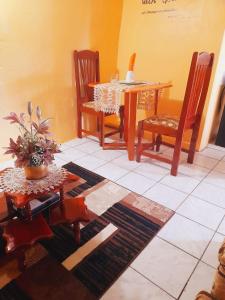 a dining room with a table and two chairs and a table and a tableablish at Faith & Peace Guest House in Fontenoy