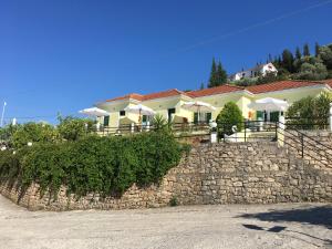 a house on top of a stone wall at Panorama in Vathi, Ithaka