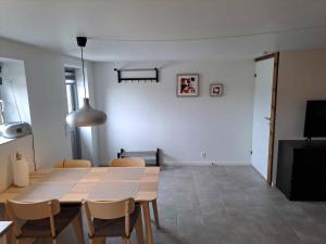 a dining room with a wooden table and chairs at Idyllic Country Apartment Incl All Utilities in Christiansfeld