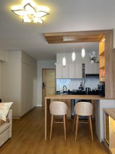 a kitchen with a table and two stools at Mini Apartment Ares 2 in Lima