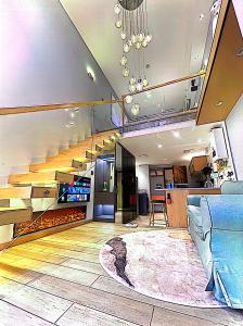 a living room with a staircase with a rug at 哲帆名宿 西永微电园龙湖高新天街Loft智能店 in Tuzhu