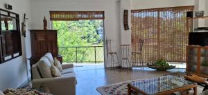 a living room with a couch and a glass table at Riverside Suites in Kandy