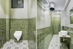 a green tiled bathroom with a toilet and a sink at Super Townhouse Chandpole Metro Station Formerly Hotel Raghuraj Palace in Jaipur +31 photos