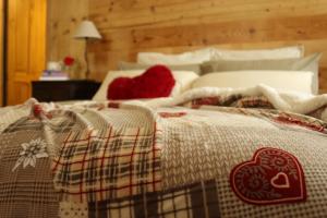 a bedroom with a bed with a blanket on it at Maison Chabod in Introd