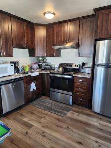 a kitchen with wooden cabinets and stainless steel appliances at 2Bedroom 1Bathroom 300 Night in San Bruno