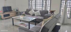 a living room with a couch and a table at Bait al-Qamar in Kampong Wakaf Tengah