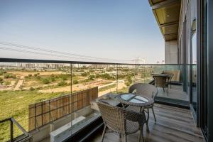 a balcony with a table and chairs and a view at Modern Duplex Retreat in Sec 71 in Gurgaon