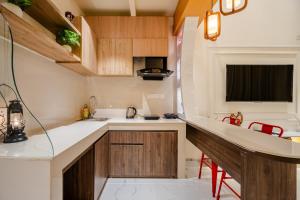 a small kitchen with wooden cabinets and a counter at Modern Duplex Retreat in Sec 71 in Gurgaon