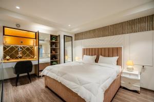 a bedroom with a large white bed and a desk at Modern Duplex Retreat in Sec 71 in Gurgaon