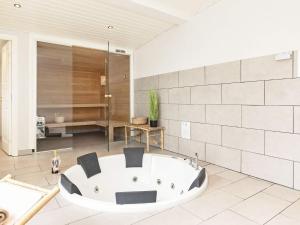 a bathroom with a bath tub in a room at Luxury Beach Retreat - By Traum Ferienwohnungen in Løkken +33 photos