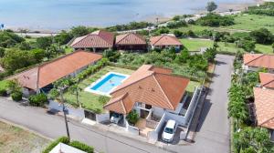an aerial view of a house with a swimming pool at Sommelier Villa ISHIGAKI in Ishigaki Island