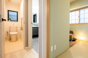 an open door to a bathroom with a toilet at Manpukuya Tanimachi in Osaka +69 photos