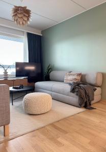 a living room with a couch and a table at Luxury Living in Rovaniemi