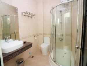 a bathroom with a sink and a shower and a toilet at Milan Hotel & Restaurant in Phnom Penh +23 photos