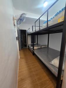 a room with two bunk beds and a hallway at Kua's Pad Batangas Private Room in Lian