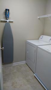 a laundry room with a washer and dryer at Peachtree TownHome in Peachtree City +12 photos