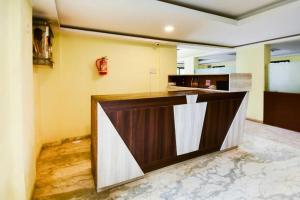 a kitchen with a brown and white counter top at Hotel O Gokul Lodging in Pune