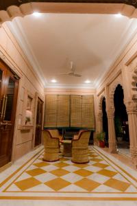 un vestíbulo con mesa y sillas en un suelo a cuadros en The heritage 100, en Jodhpur