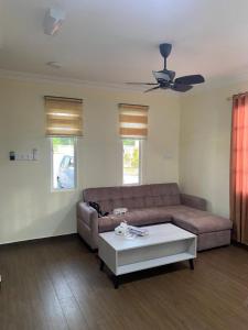 a living room with a couch and a coffee table at D'Cottage in Kuala Penyu