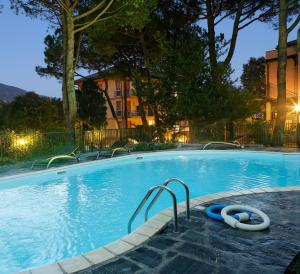 a large swimming pool with two inflatable tubes in it at Hotel Villa Adriana in Monterosso al Mare