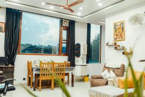 a living room with a table and a couch at JM Luxury Homestays in Jawāla Mukhi