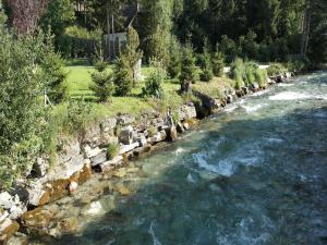 a river with rocks and trees on the side at Chalet in Mauterndorf near Ski Lift in Mauterndorf