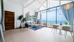 a living room with a view of the ocean at v14 Serenity Bay Panoramic Sea View in Haad Yao